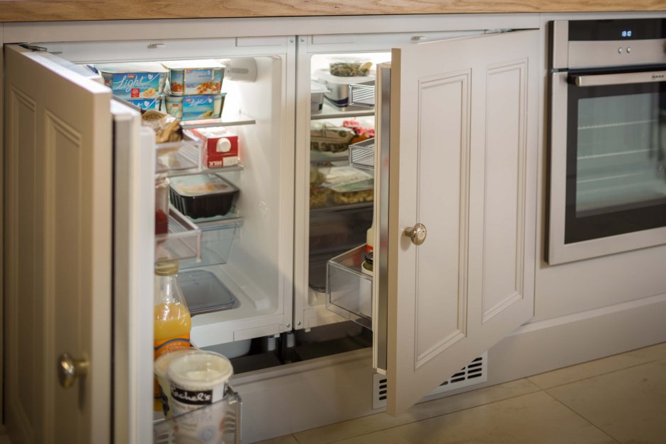 Интерьер кухни с холодильником у двери