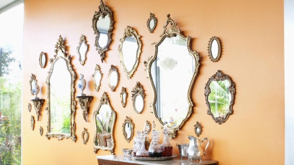 Зеркала в разных рамках на стене