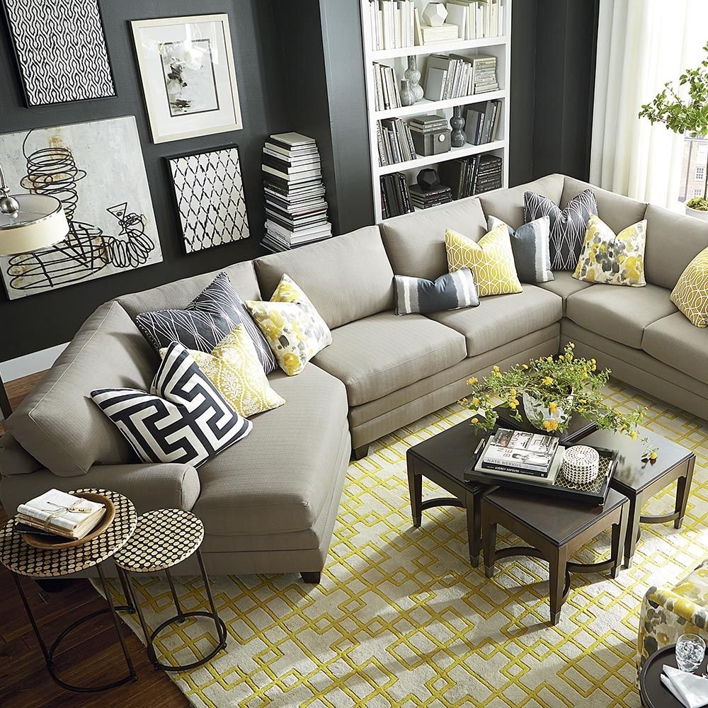 Next to the sofa. Серый диван в интерьере. Гостиная с серым диваном. Диван серого цвета в интерьере. Серый диван с подушками.