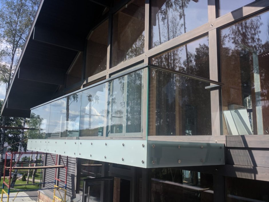 Балконы в многоэтажном доме со стеклянным ограждением