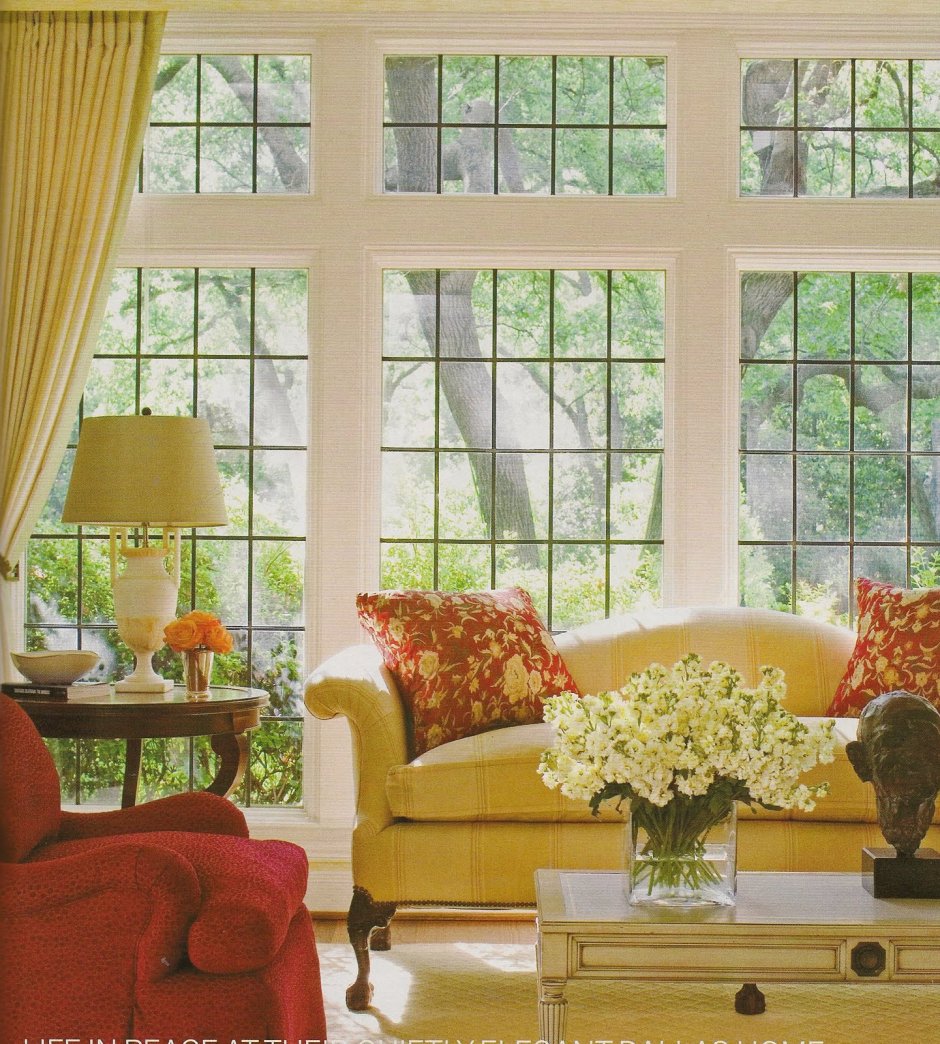 Two large Windows in the Living Room. Nice Curtains on the Windows. Ig Yellow Sofa at the Windows. On the right.