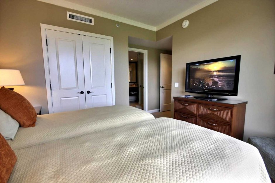 Телевизор над кроватью в спальне