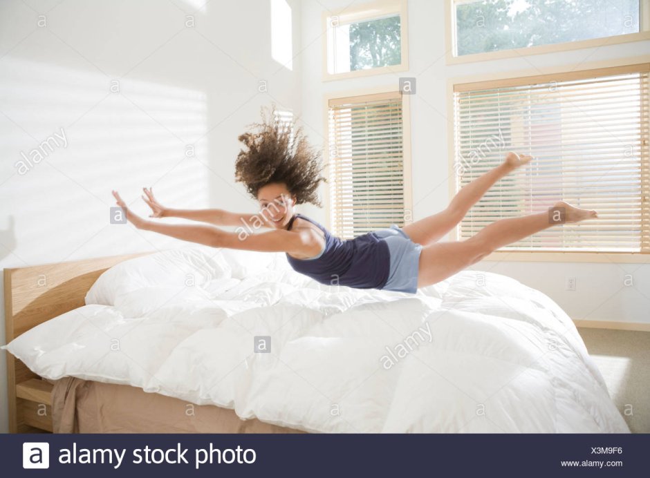 Девушка в прыжке на кровать
