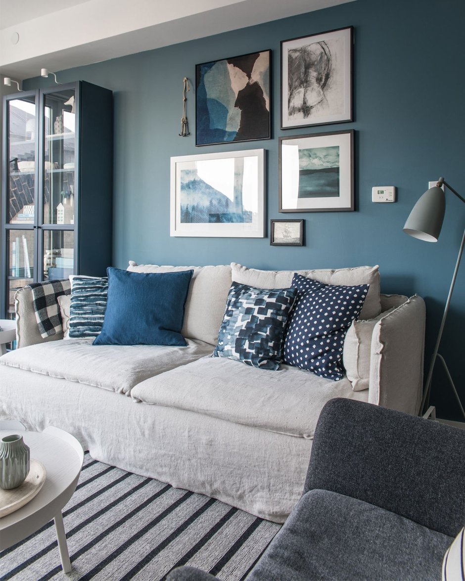 Синий диван с подушками в интерьере