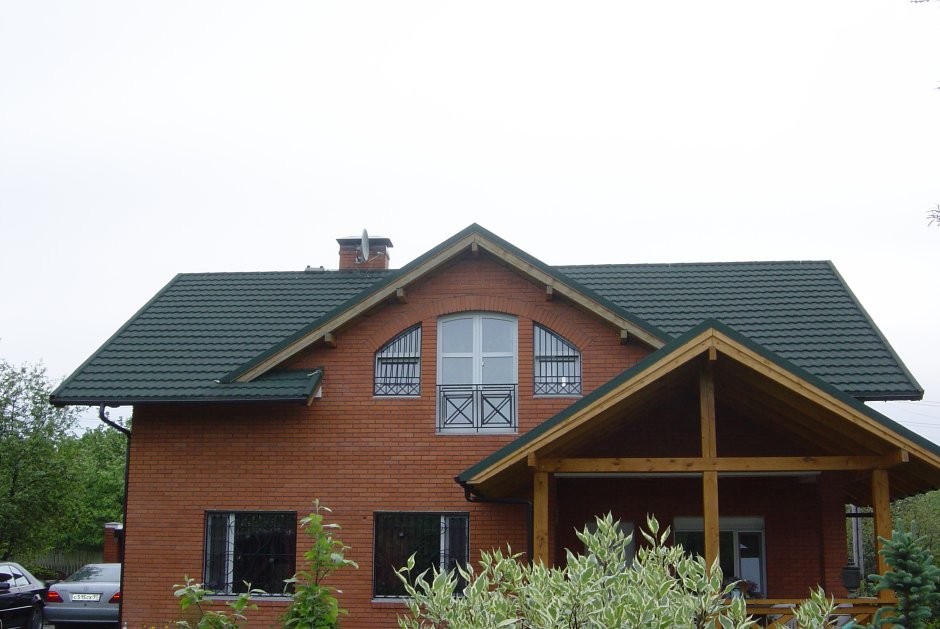 Темный дом с зеленой крышей