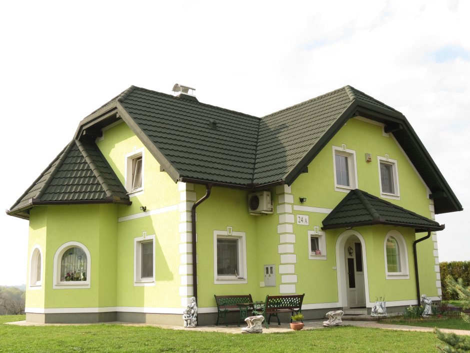 Кирпичный дом с зеленой крышей
