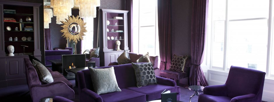 Коричневый диван и фиолетовые шторы