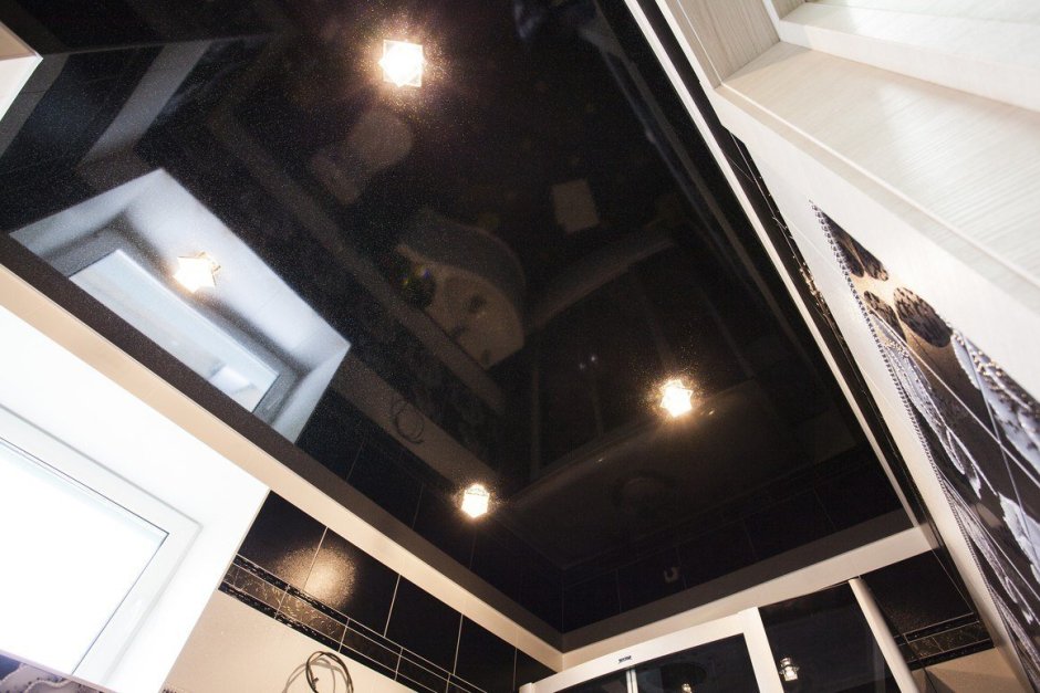 Интерьер в комнате мужчины с черным натяжным потолком