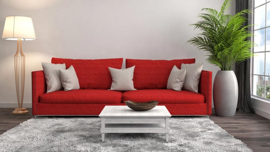 Серый диван с красными подушками в интерьере