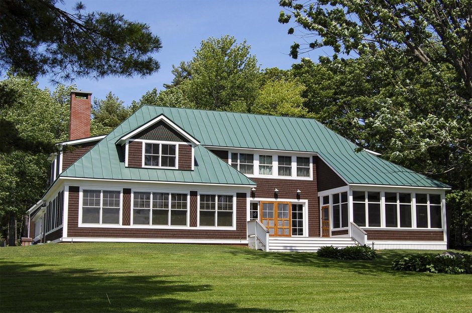 Темно зеленый дом с коричневой крышей
